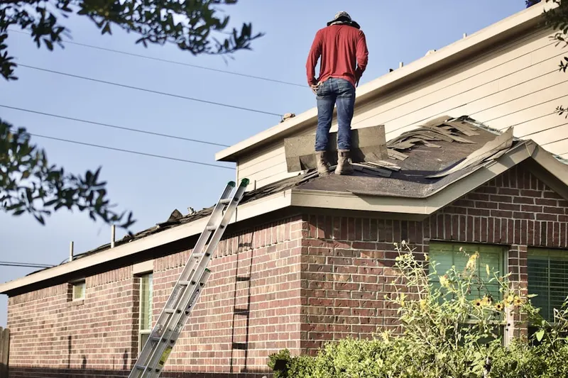 Professional roofer working on a residential roof in Princeton Village